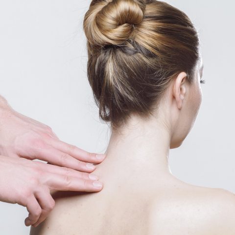 Fysiotherapeut behandelt de schouder van een patiënt in een fysiotherapiepraktijk