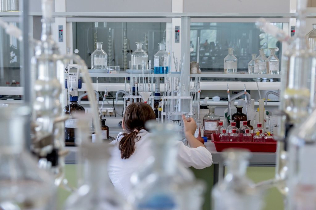 Wetenschapper in laboratorium die grafeenmateriaal onderzoekt onder microscoop
