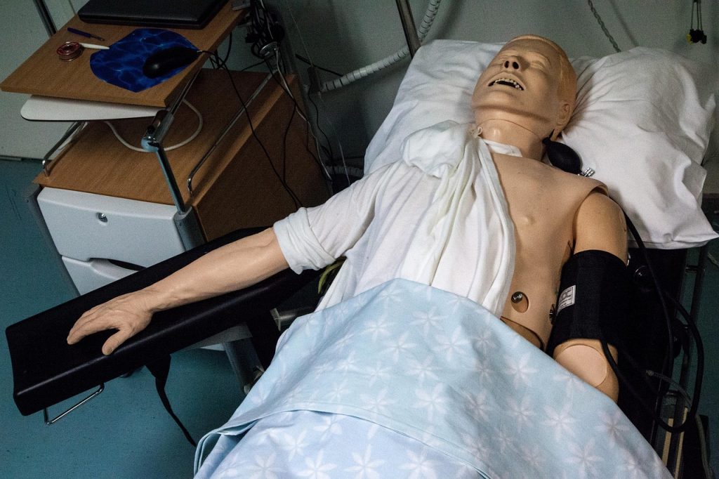 Cursist oefent reanimatie op een trainingsmanequin tijdens een EHBO-cursus