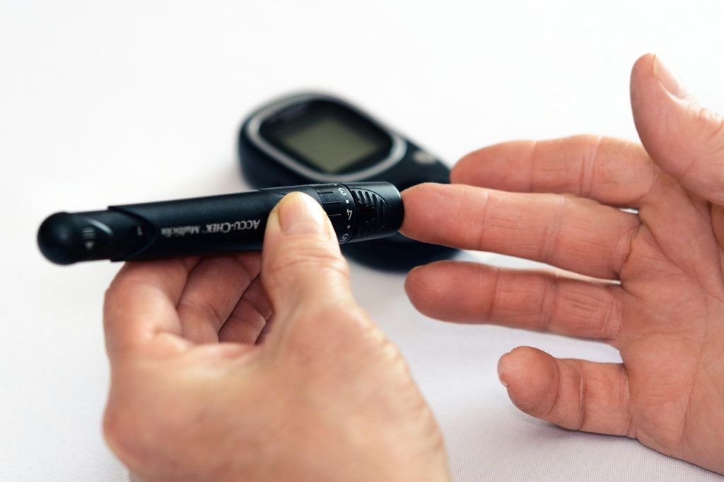 Arts die de bloedsuiker controleert bij een patiënt met diabetes type 2
