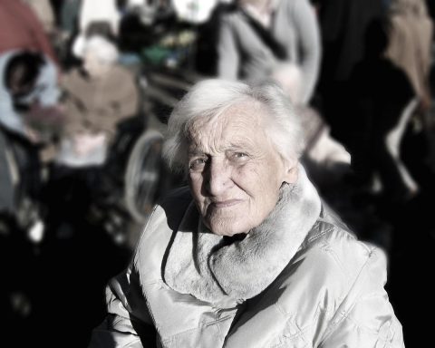 Een oudere vrouw zit samen met een mantelzorger aan tafel en bespreekt zorgopties